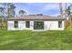 Expansive backyard with lush lawn, sliding glass doors, and bright natural light for outdoor enjoyment at 4546 Padgette St, North Port, FL 34291