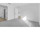 Bright bedroom featuring neutral carpet, white walls, and doorway to ensuite bathroom at 4546 Padgette St, North Port, FL 34291