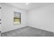 Bright bedroom featuring neutral carpet, white walls, and window with blinds at 4546 Padgette St, North Port, FL 34291