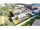 Aerial view showcasing the backyard's fenced perimeter, screened patio, and cozy fire pit at 5215 New Brittany Ln, Zephyrhills, FL 33541