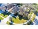 An aerial perspective reveals a well-maintained home with a green lawn, mature trees, and a welcoming entrance at 5215 New Brittany Ln, Zephyrhills, FL 33541