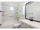 Well lit bathroom featuring a modern sink and vanity, a toilet and tiled bath and shower combo at 5215 New Brittany Ln, Zephyrhills, FL 33541