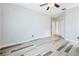 Spacious bedroom featuring wood flooring, neutral paint, and a ceiling fan at 5215 New Brittany Ln, Zephyrhills, FL 33541