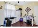 Office area with a desk, computer, cabinets, drawers, ceiling fan, and dark wood flooring at 5215 New Brittany Ln, Zephyrhills, FL 33541