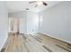 Bright bedroom featuring stylish multicolored floors, a ceiling fan, and an attached bathroom with walk in closet at 5215 New Brittany Ln, Zephyrhills, FL 33541