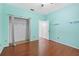 Bright bedroom with hardwood floors, walk-in closet, and fresh paint at 5215 New Brittany Ln, Zephyrhills, FL 33541