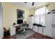 Office area with a desk, computer, cabinets, drawers, ceiling fan, and dark wood flooring at 5215 New Brittany Ln, Zephyrhills, FL 33541