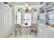 Cozy breakfast nook with a round table, decorative cabinet, and natural light from the bay window at 5215 New Brittany Ln, Zephyrhills, FL 33541