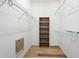 Walk-in closet featuring a built-in shelving unit and white wire shelving providing ample storage space at 5215 New Brittany Ln, Zephyrhills, FL 33541