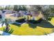 Charming one-story home boasts a lush lawn and vibrant yellow facade with mature landscaping at 5215 New Brittany Ln, Zephyrhills, FL 33541