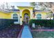 Close-up of the entrance featuring a decorative glass door framed by archways and lush greenery at 5215 New Brittany Ln, Zephyrhills, FL 33541