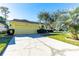 Inviting single-story home with lush landscaping, a two car garage, and extended driveway at 5215 New Brittany Ln, Zephyrhills, FL 33541