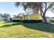 Charming one-story home with a well-manicured lawn and mature tree enhancing its curb appeal at 5215 New Brittany Ln, Zephyrhills, FL 33541