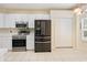Well-equipped kitchen featuring stainless steel appliances and ample cabinet space at 5215 New Brittany Ln, Zephyrhills, FL 33541