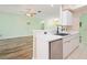 Bright kitchen featuring white cabinets, modern faucet, and an open view to the living room at 5215 New Brittany Ln, Zephyrhills, FL 33541