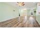 Spacious open-concept living area with updated flooring, light-colored walls, and a ceiling fan at 5215 New Brittany Ln, Zephyrhills, FL 33541