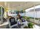 Relaxing screened patio with comfortable seating and outdoor views at 5215 New Brittany Ln, Zephyrhills, FL 33541