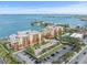 Stunning aerial view of condo community with lush landscaping and ample parking near the waterfront at 5301 Gulf Blvd # E202, St Pete Beach, FL 33706