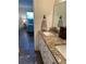 Bathroom vanity with granite countertop, double sinks and access to the bedroom at 6020 Shore Blvd S # 109, Gulfport, FL 33707