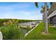 Waterfront backyard features a grassy lawn, mature palms and direct water access at 8829 Bay Pointe Dr # 205, Tampa, FL 33615