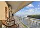Covered balcony with seating offers beautiful water views, perfect for relaxing and enjoying the scenery at 8829 Bay Pointe Dr # 205, Tampa, FL 33615