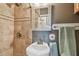 Bathroom features tiled shower, decorative mirror, and a pedestal sink at 8829 Bay Pointe Dr # 205, Tampa, FL 33615
