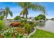 The community's entrance sign has beautiful red and white flowers, and a water view at 8829 Bay Pointe Dr # 205, Tampa, FL 33615