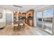 Bright kitchen featuring travertine tile, granite counters, and a center island with breakfast bar seating at 8829 Bay Pointe Dr # 205, Tampa, FL 33615