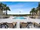 Community pool with sun loungers, tables, and water views at 8829 Bay Pointe Dr # 205, Tampa, FL 33615