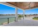 Expansive balcony overlooking the waterfront with glass railings and wood ceiling at 17059 Dolphin Dr, North Redington Beach, FL 33708