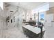 Luxurious bathroom with a glass shower enclosure, a soaking tub, and dual vanity at 17059 Dolphin Dr, North Redington Beach, FL 33708