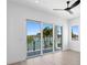 Bright bedroom with waterfront view, hardwood floors, and sliding glass doors at 17059 Dolphin Dr, North Redington Beach, FL 33708