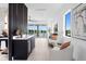 Bright, modern living area with wet bar featuring water views and stylish furniture at 17059 Dolphin Dr, North Redington Beach, FL 33708