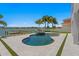 Resort-style pool area with a custom pool, spa, and waterfront views at 17059 Dolphin Dr, North Redington Beach, FL 33708