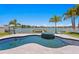 Custom-shaped pool and spa overlooking the waterfront, surrounded by lush landscaping at 17059 Dolphin Dr, North Redington Beach, FL 33708