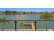 Picturesque waterfront view featuring a private dock and palm trees set against a serene canal and neighborhood backdrop at 17059 Dolphin Dr, North Redington Beach, FL 33708