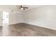 Bright bedroom with neutral walls, wood-look floors, ceiling fan, and closet at 3721 9Th S Ave, St Petersburg, FL 33711
