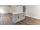 Open floorplan features a kitchen island with white countertop and new wood flooring at 3721 9Th S Ave, St Petersburg, FL 33711