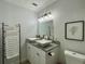 Bathroom featuring double sinks, granite countertop, and modern fixtures at 4684 25Th S Ave, St Petersburg, FL 33711