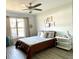 Cozy bedroom features wood floors, neutral tones, and a large window for natural light at 4684 25Th S Ave, St Petersburg, FL 33711