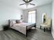 Bedroom with ceiling fan and decorative chair bathed in natural light from window at 4684 25Th S Ave, St Petersburg, FL 33711