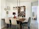 Dining room with rectangular wood table, modern light fixture, and accent wall decor at 4684 25Th S Ave, St Petersburg, FL 33711