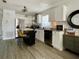 Bright kitchen with white cabinetry, stainless steel appliances, and wood-look flooring at 4684 25Th S Ave, St Petersburg, FL 33711