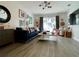 Bright living room featuring hardwood floors, a comfortable sofa, and a modern light fixture at 4684 25Th S Ave, St Petersburg, FL 33711