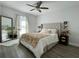 Main bedroom featuring a large bed, hardwood floors, natural light, and neutral decor at 4684 25Th S Ave, St Petersburg, FL 33711