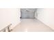 Spacious two car garage with light gray painted floor and white walls at 7815 Bronze Oak Dr, Wesley Chapel, FL 33545