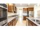 Stylish kitchen featuring stainless steel appliances, granite countertops, and dark wood cabinets at 7815 Bronze Oak Dr, Wesley Chapel, FL 33545