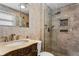 Bathroom features a modern vanity with a marble countertop and glass shower at 8716 Hickorywood Ln, Tampa, FL 33615
