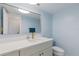 Charming bathroom with a modern vanity, white countertops, and elegant gold fixtures at 8716 Hickorywood Ln, Tampa, FL 33615