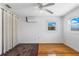 Bedroom featuring hardwood floors, ceiling fan, AC unit, and a window for natural light at 8716 Hickorywood Ln, Tampa, FL 33615